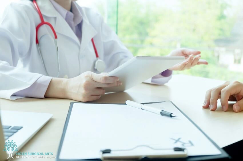 A cosmetic surgery consultant is conversing with a patient at a desk.