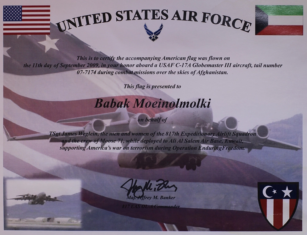 An American flag displayed alongside a United States Air Force certificate.