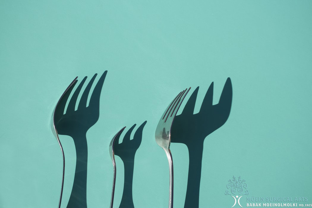 Three forks with shadows on a blue background.