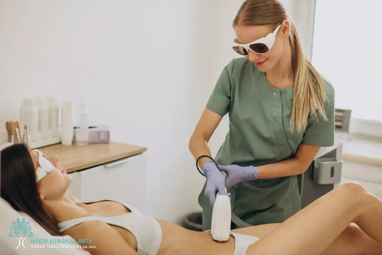 A woman is getting a laser treatment on her body.