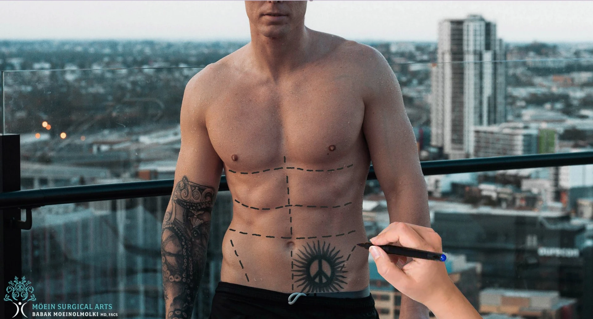 A man is drawing a tattoo on his stomach.